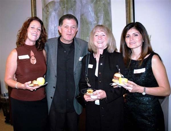 A group of people holding fruit in their hands.