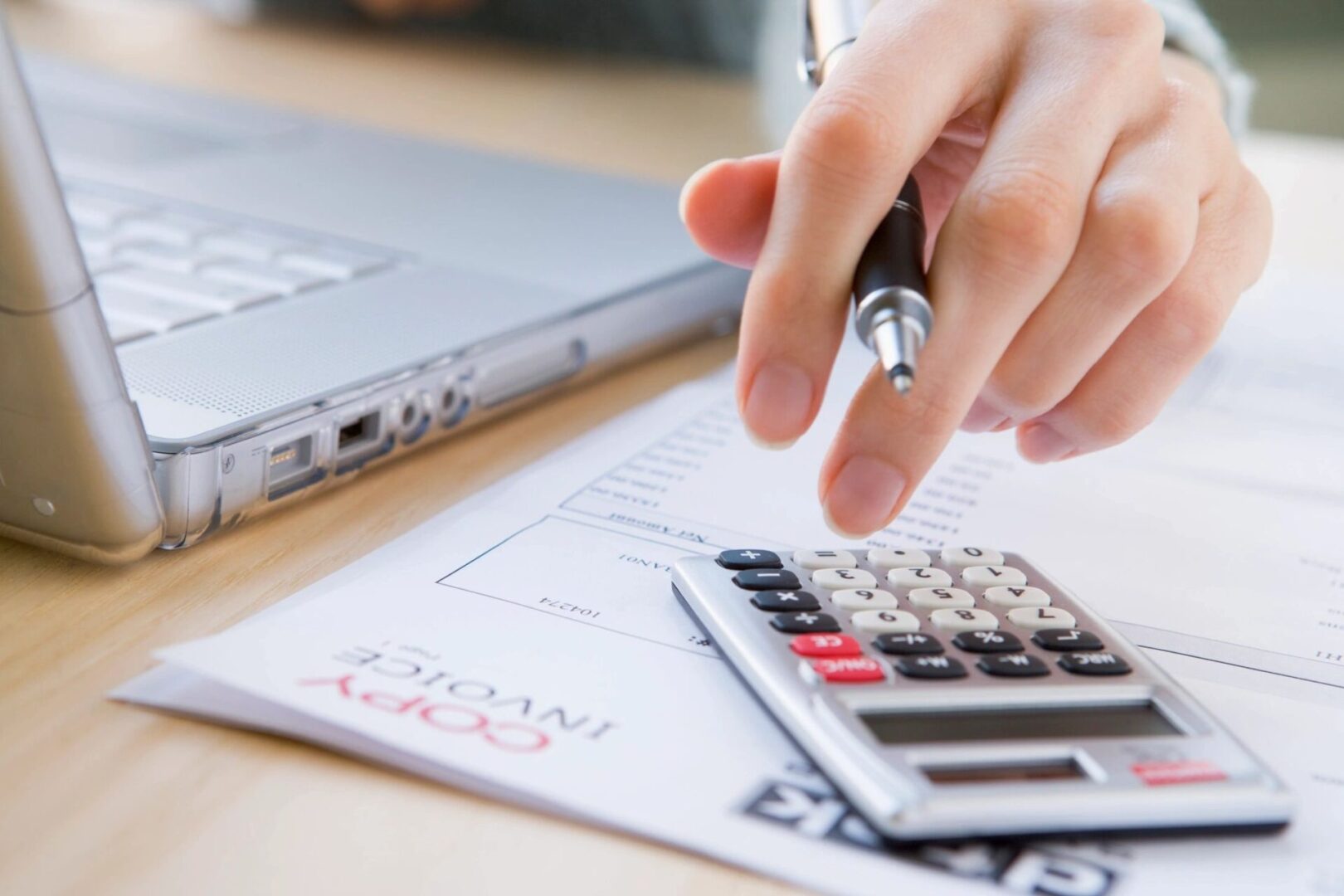 A person is using a calculator to calculate their taxes.